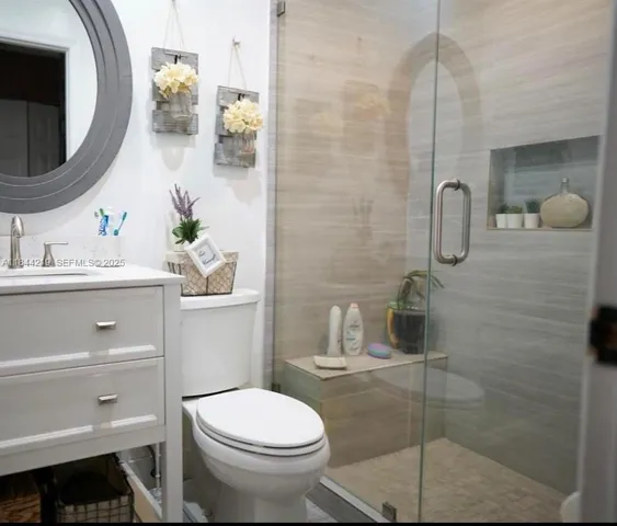 a bathroom with a sink toilet and shower