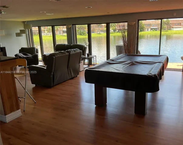 a living room with furniture and large windows