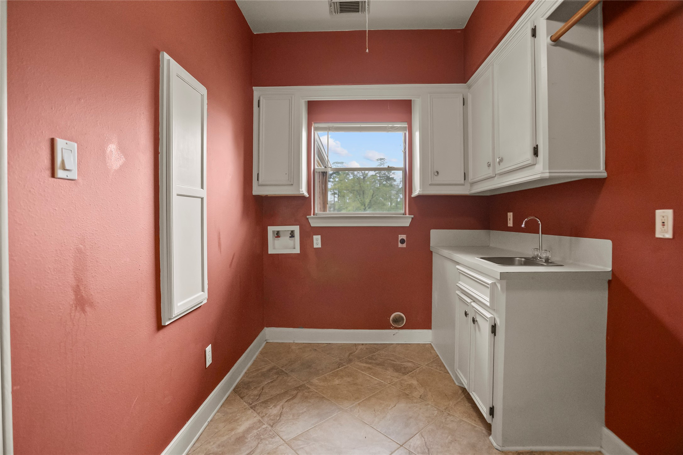 22916 East Martin Drive Porter, TX 77365 - Photo 33 of 43 a utility room with a sink a window and cabinets