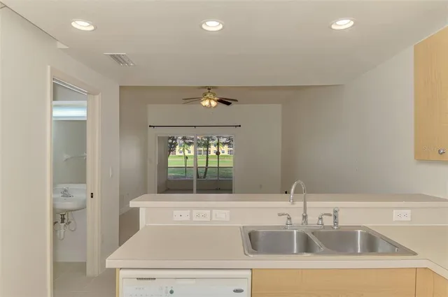 an empty room with a ceiling fan and a window