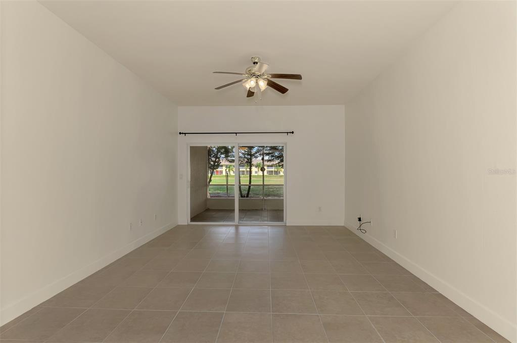 1246 Rio De Janeiro Avenue, Unit 510 Punta Gorda, FL 33983 - Photo 14 of 52 an empty room with a ceiling fan and a window