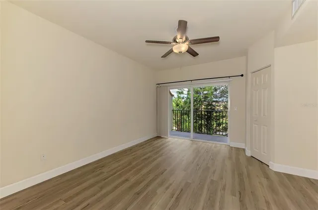 a view of empty room with wooden floor