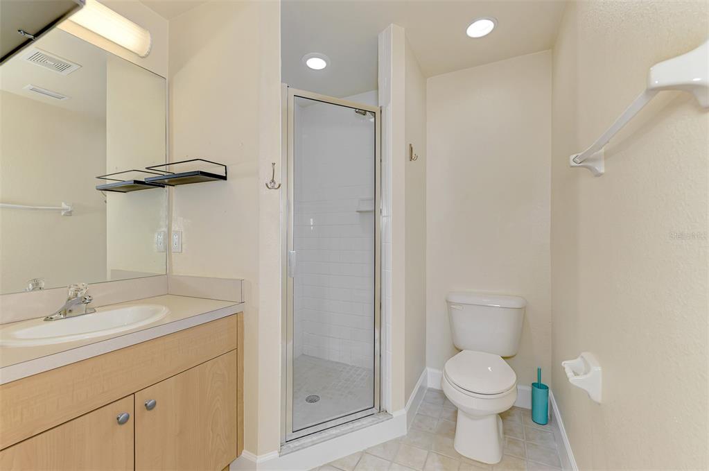 1246 Rio De Janeiro Avenue, Unit 510 Punta Gorda, FL 33983 - Photo 24 of 52 a bathroom with a granite countertop toilet a sink a mirror and vanity