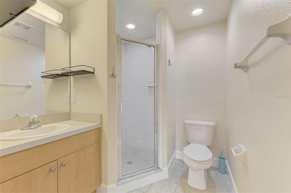 1246 Rio De Janeiro Avenue, Unit 510 Punta Gorda, FL 33983 - Photo 25 of 52 a bathroom with a granite countertop sink toilet and shower