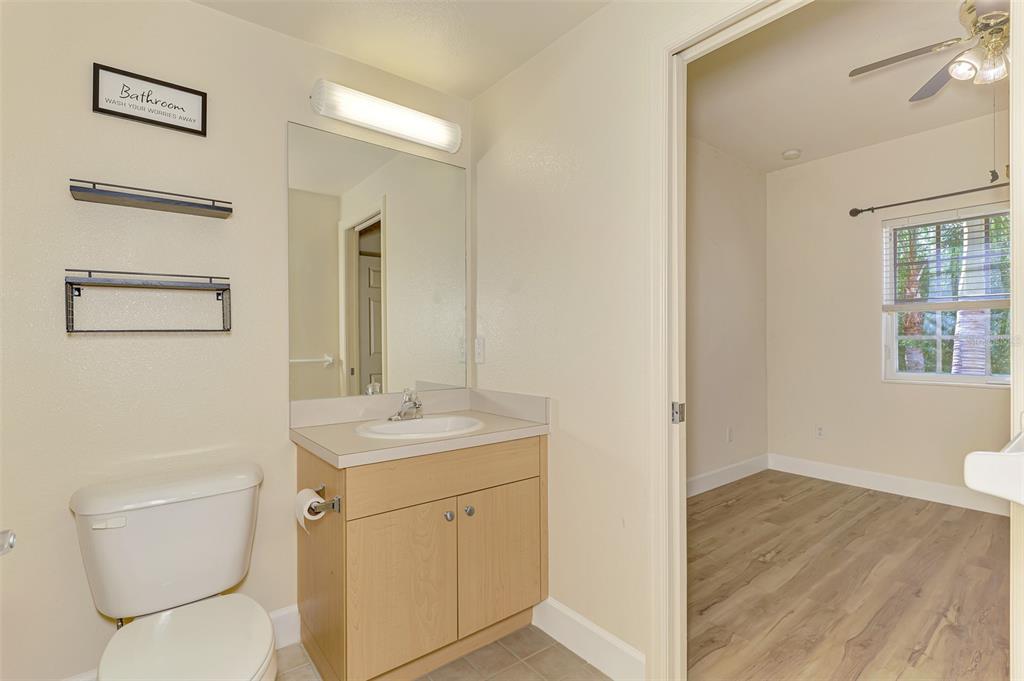 1246 Rio De Janeiro Avenue, Unit 510 Punta Gorda, FL 33983 - Photo 31 of 52 a bathroom with a toilet sink and mirror