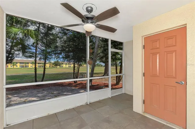 a view of a room with wooden floor and a ceiling fan