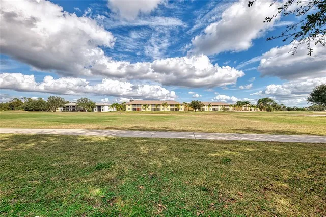 a view of a house with backyard and tree