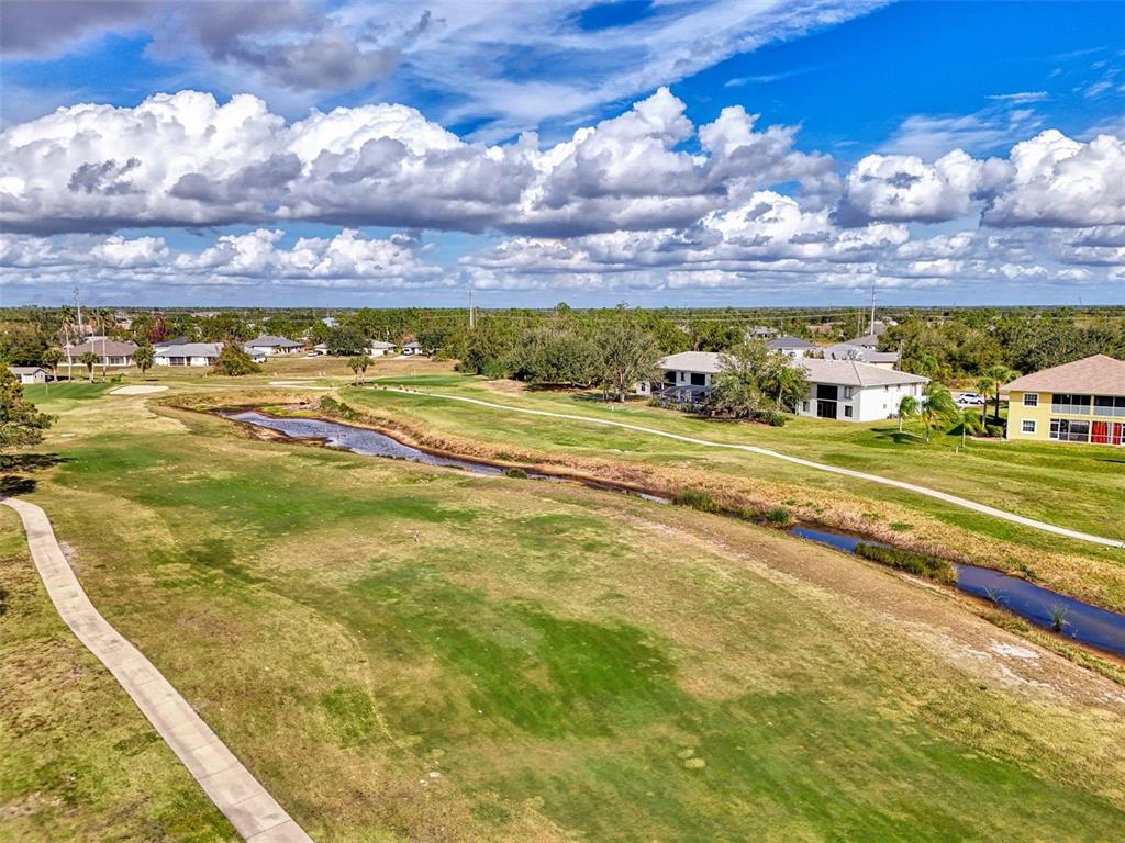 1246 Rio De Janeiro Avenue, Unit 510 Punta Gorda, FL 33983 - Photo 42 of 52 a view of an ocean with a nearby beach