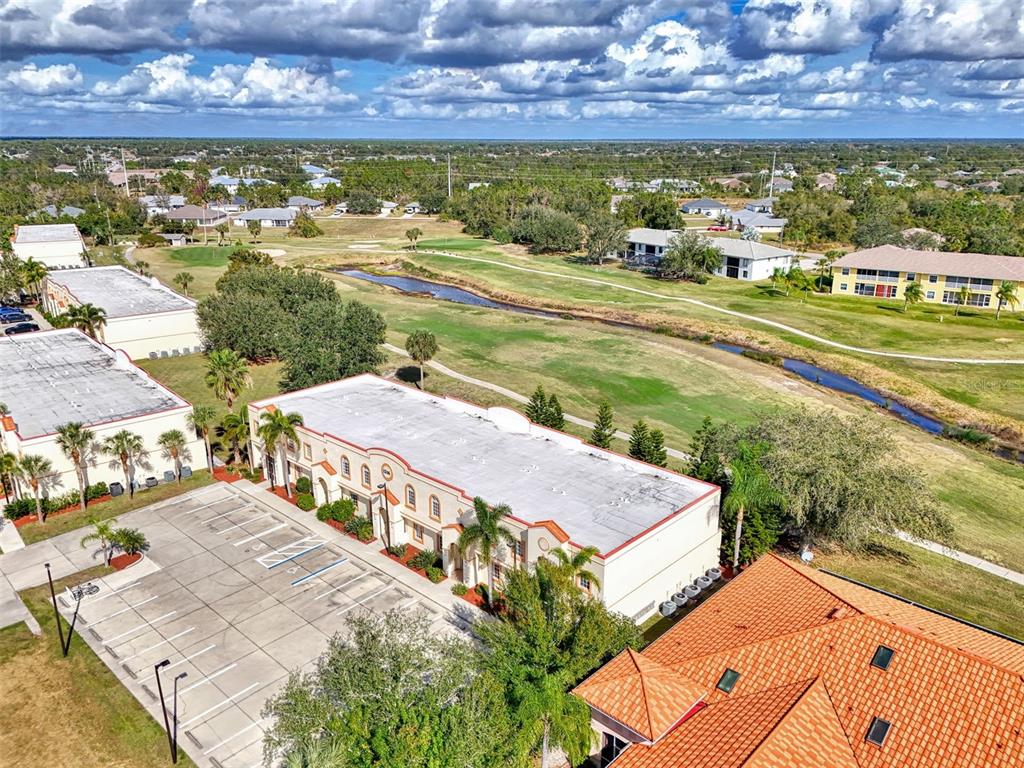 1246 Rio De Janeiro Avenue, Unit 510 Punta Gorda, FL 33983 - Photo 49 of 52 a view of an swimming pool with a yard