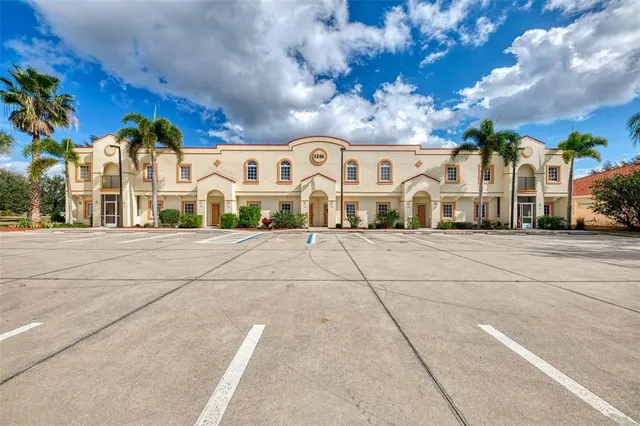 a view of a building with cars parked