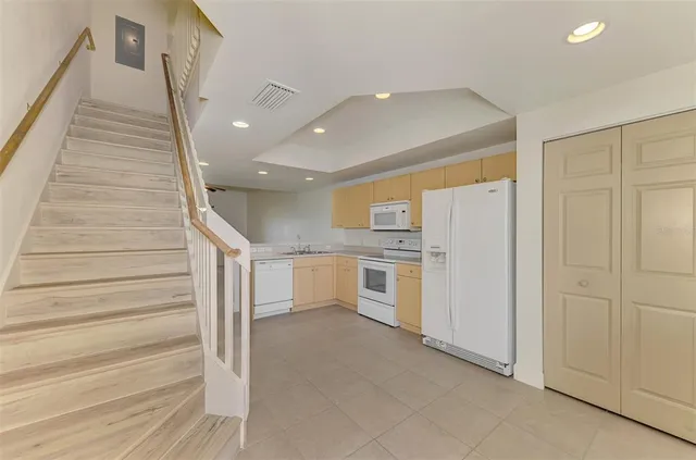 a view of a kitchen with cabinets and wooden floor