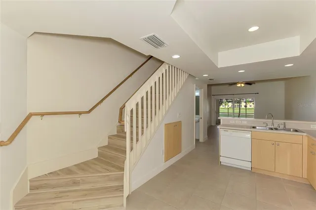 a kitchen with cabinets a sink and white stainless steel appliances