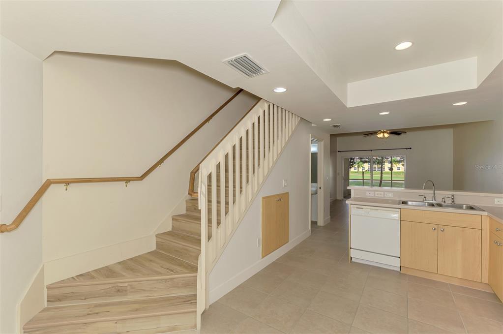 1246 Rio De Janeiro Avenue, Unit 510 Punta Gorda, FL 33983 - Photo 6 of 52 a view of a kitchen with cabinets and wooden floor