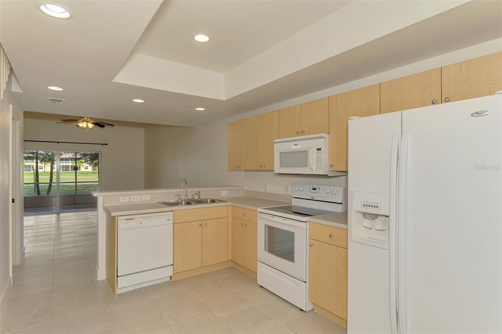 1246 Rio De Janeiro Avenue, Unit 510 Punta Gorda, FL 33983 - Photo 7 of 52 a kitchen with cabinets a sink and white stainless steel appliances