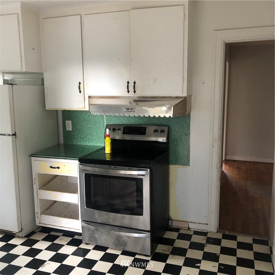 1311 McClellan Street Aberdeen, WA 98520 - Photo 8 of 29 a stove top oven sitting inside of a kitchen