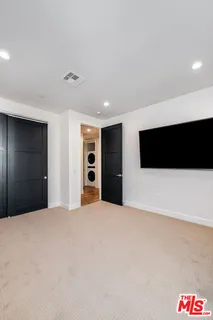 a large white bed in a white room