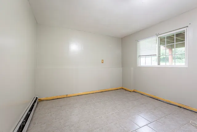 an empty room with windows and closet