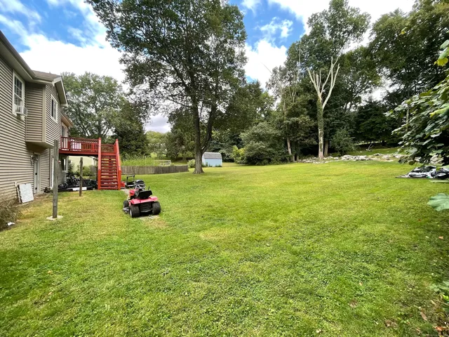 a view of a house with a backyard and a slide