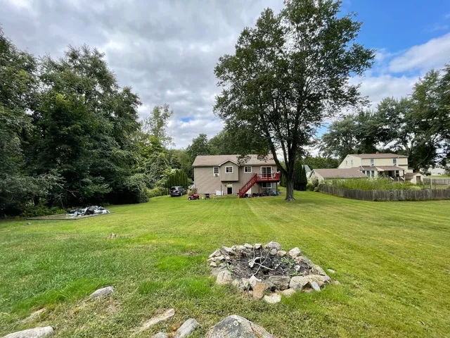 a view of a field with trees in front of it