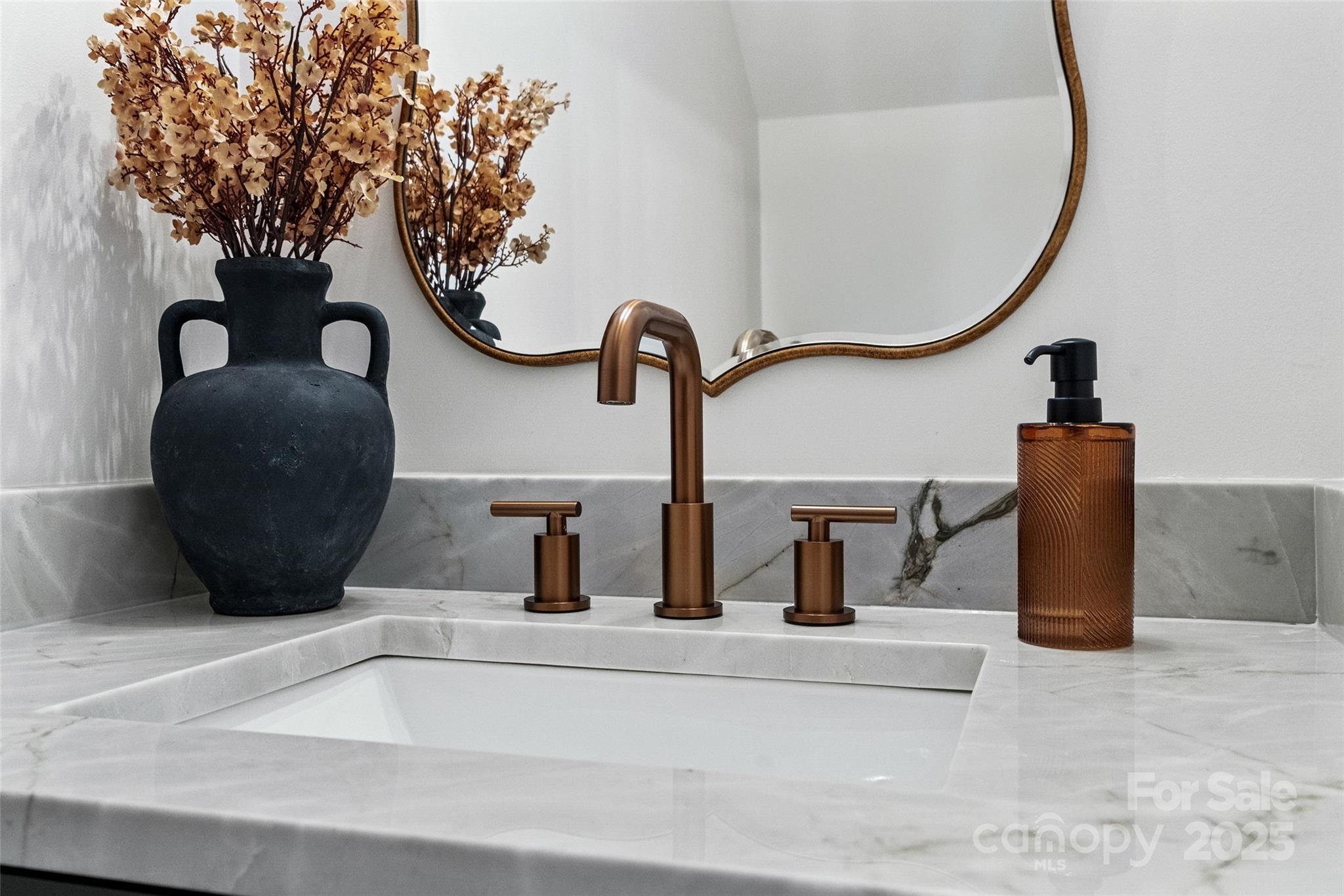 11708 Huxley Road Charlotte, NC 28277 - Photo 20 of 40 a bathroom with a sink and a mirror