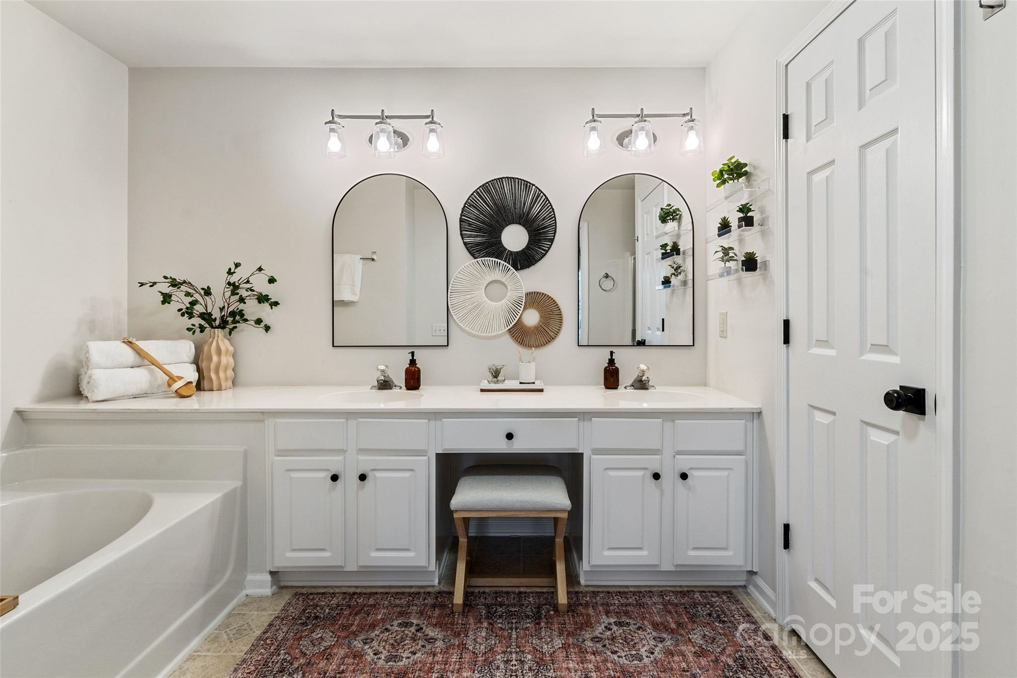11708 Huxley Road Charlotte, NC 28277 - Photo 25 of 40 a spacious bathroom with a double vanity sink and a mirror