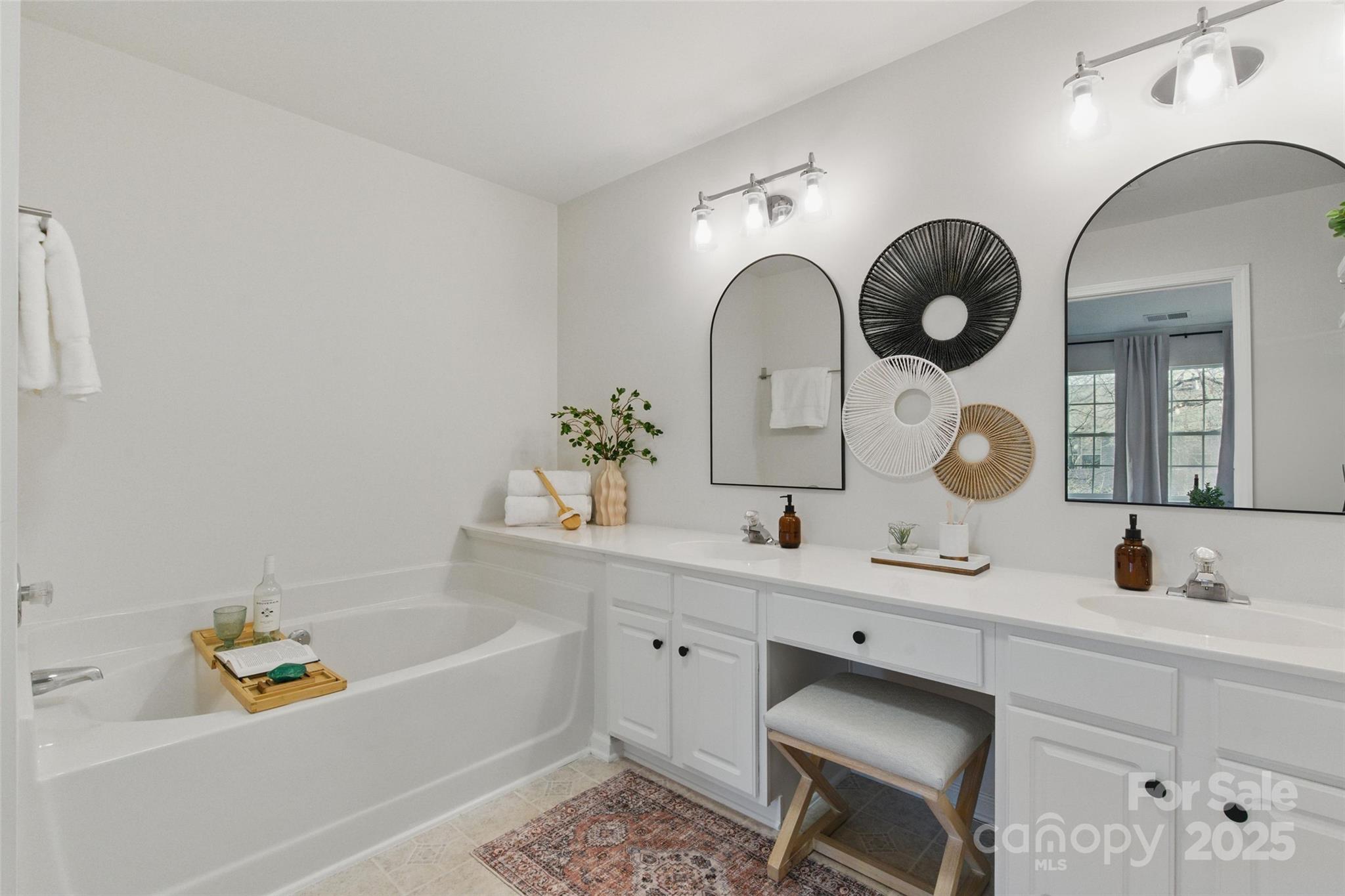 11708 Huxley Road Charlotte, NC 28277 - Photo 26 of 40 a bathroom with a tub sink and mirror
