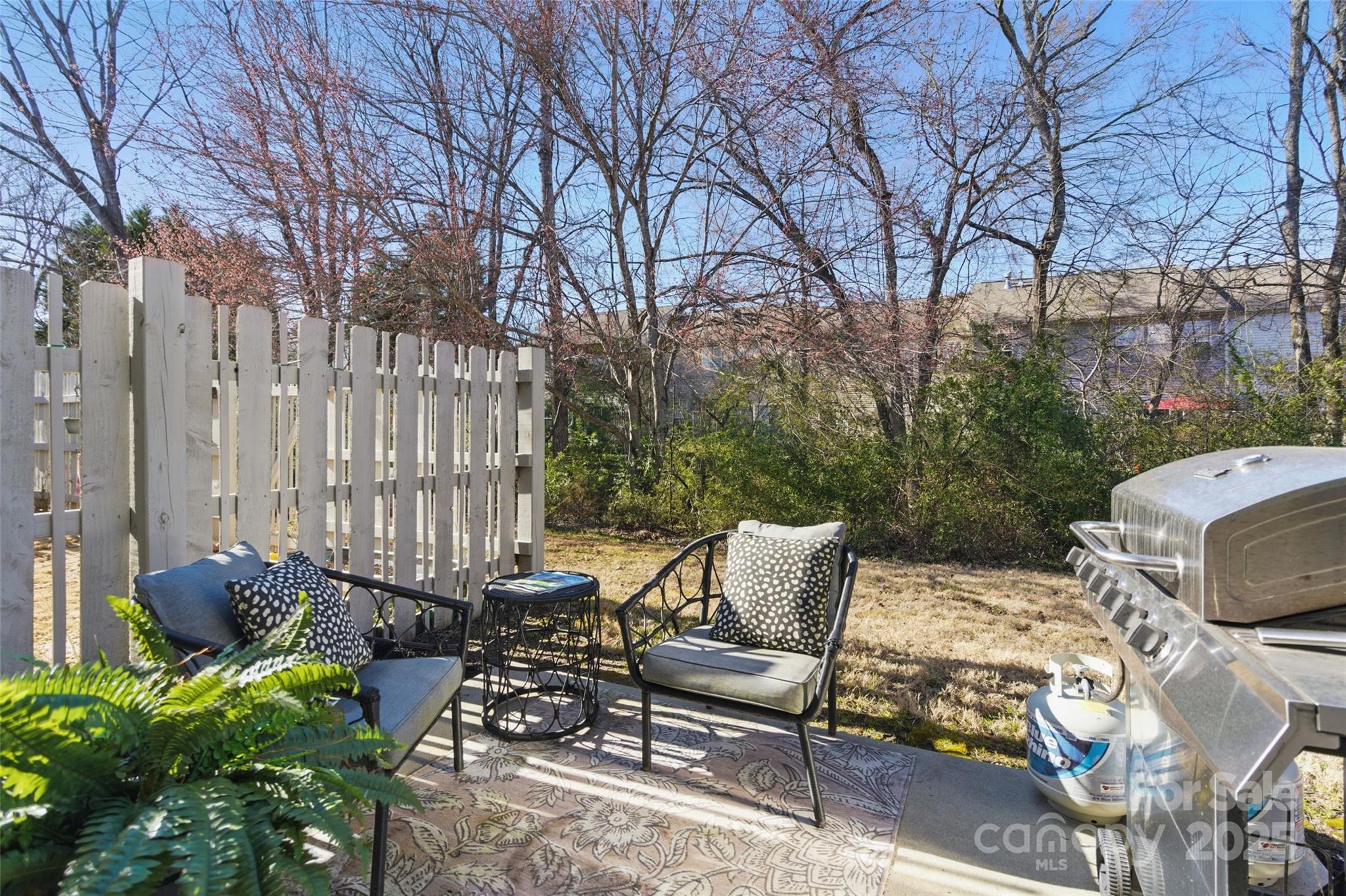 11708 Huxley Road Charlotte, NC 28277 - Photo 32 of 40 a view of backyard with outdoor seating and trees