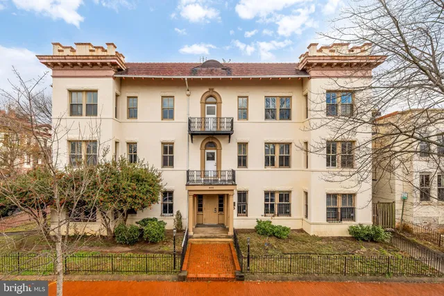 a view of white house with a yard