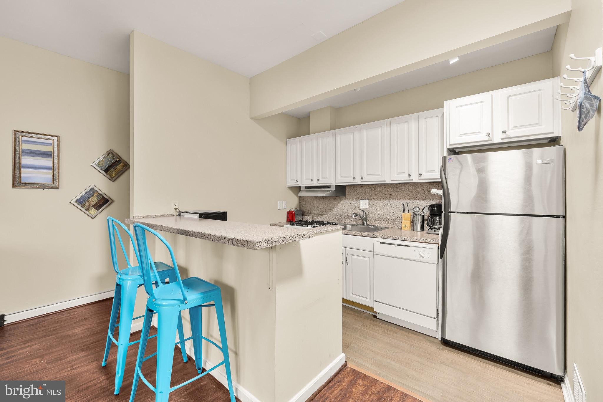 500 9th Street Southeast Washington, DC 20003 - Photo 18 of 34 a kitchen with stainless steel appliances a refrigerator sink and white cabinets
