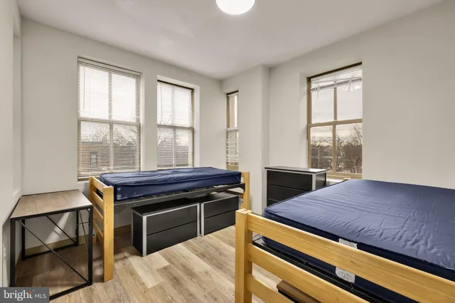 a bedroom with bunk bed and a window