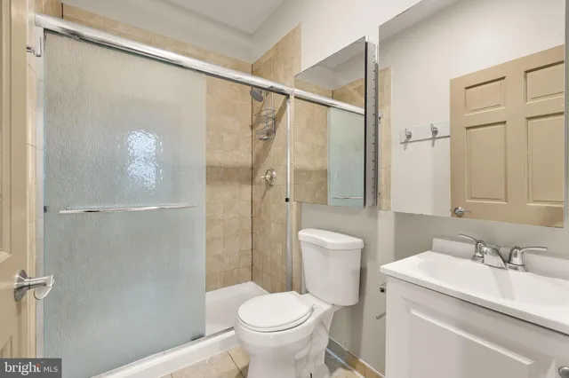 a kitchen with a table chairs refrigerator and cabinets
