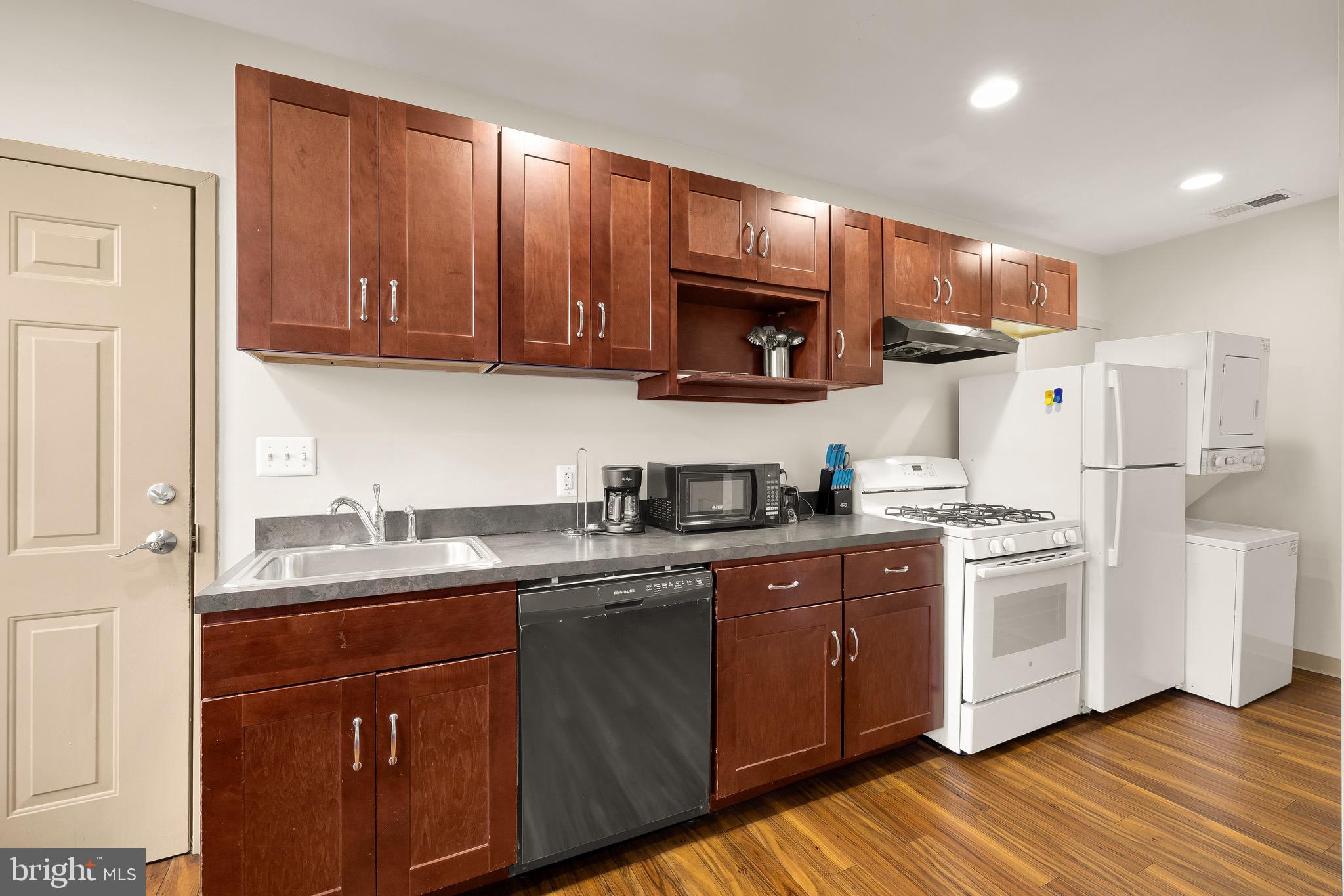 500 9th Street Southeast Washington, DC 20003 - Photo 29 of 34 a kitchen with stainless steel appliances granite countertop a sink a stove a refrigerator cabinets and a window