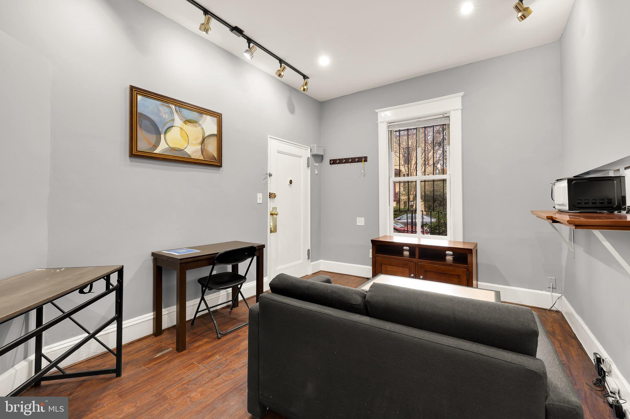 500 9th Street Southeast Washington, DC 20003 - Photo 3 of 34 a living room with furniture and a flat screen tv