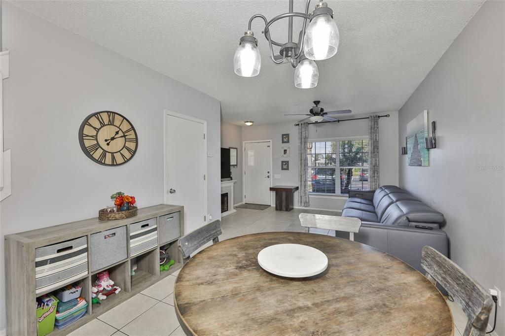 477 Countryside Key Boulevard Oldsmar, FL 34677 - Photo 11 of 46 a living room with dining table furniture and a large window