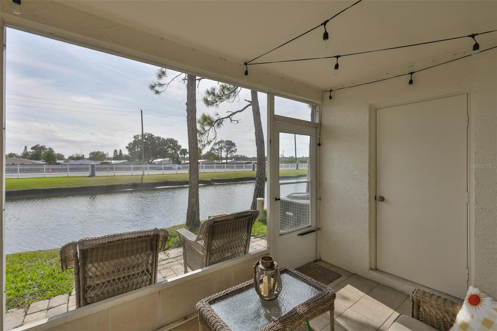 477 Countryside Key Boulevard Oldsmar, FL 34677 - Photo 19 of 46 a living room with a floor to ceiling window and wooden floor
