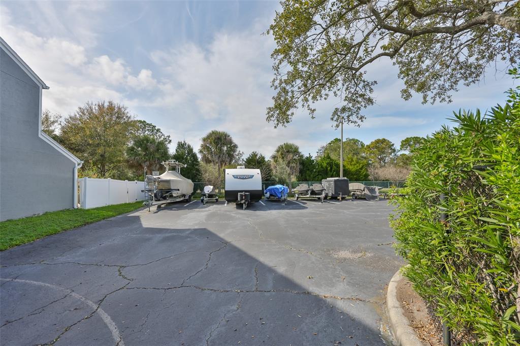 477 Countryside Key Boulevard Oldsmar, FL 34677 - Photo 32 of 46 a view of a patio with a table and chairs under an umbrella