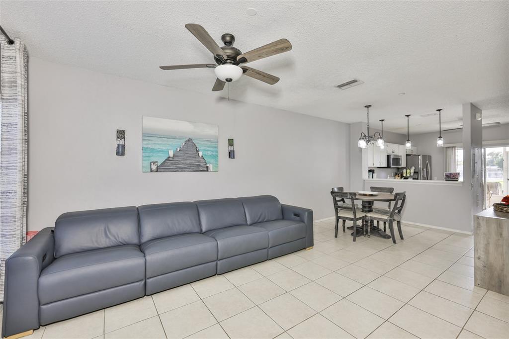 477 Countryside Key Boulevard Oldsmar, FL 34677 - Photo 4 of 46 a living room with furniture and a view of kitchen