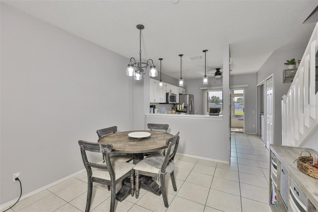 477 Countryside Key Boulevard Oldsmar, FL 34677 - Photo 6 of 46 a view of a dining room with furniture and chandelier