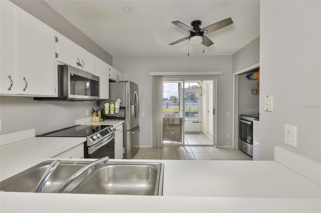477 Countryside Key Boulevard Oldsmar, FL 34677 - Photo 8 of 46 a kitchen with stainless steel appliances granite countertop a sink a stove and a refrigerator