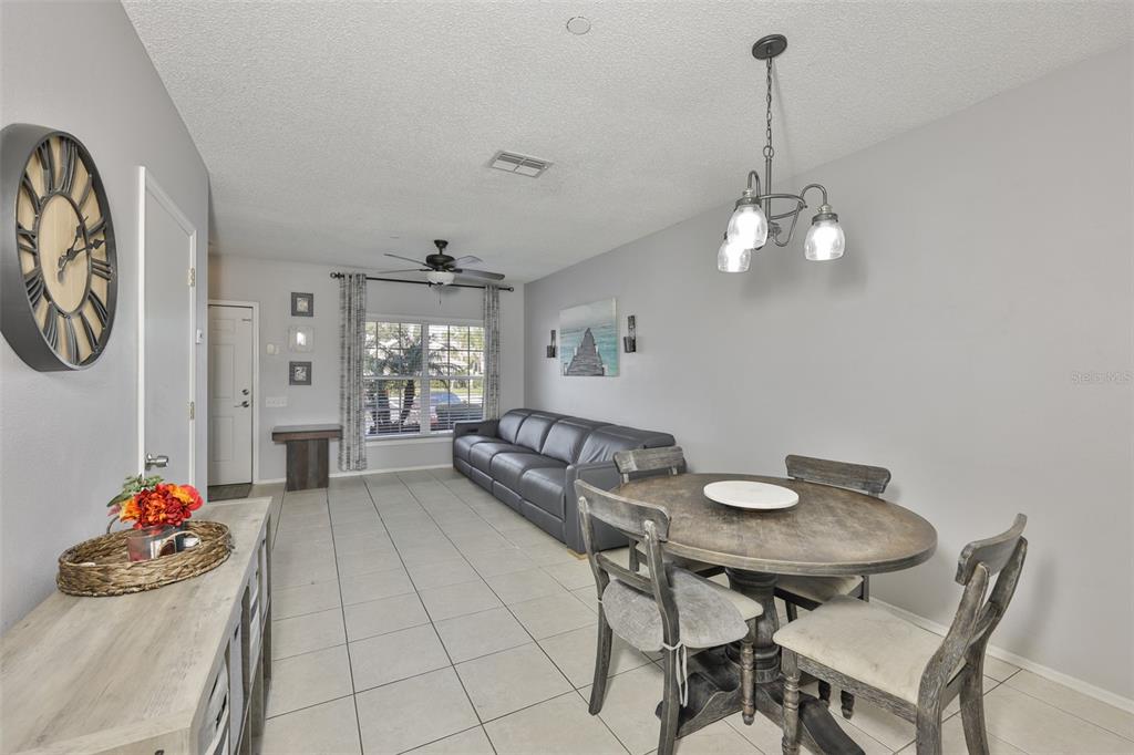 477 Countryside Key Boulevard Oldsmar, FL 34677 - Photo 10 of 46 a living room with furniture and chandelier