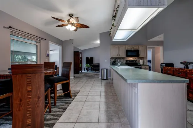 a kitchen with stainless steel appliances granite countertop a sink and a refrigerator
