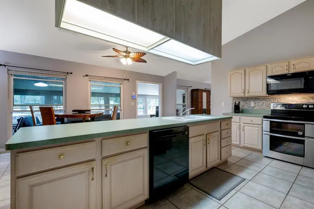 a kitchen with stainless steel appliances granite countertop a sink and cabinets