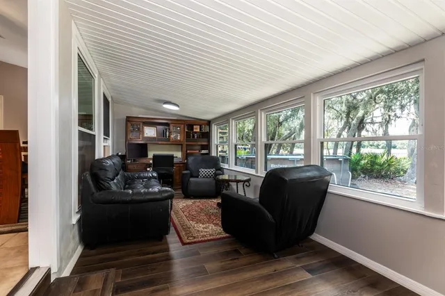 a living room with furniture and large windows