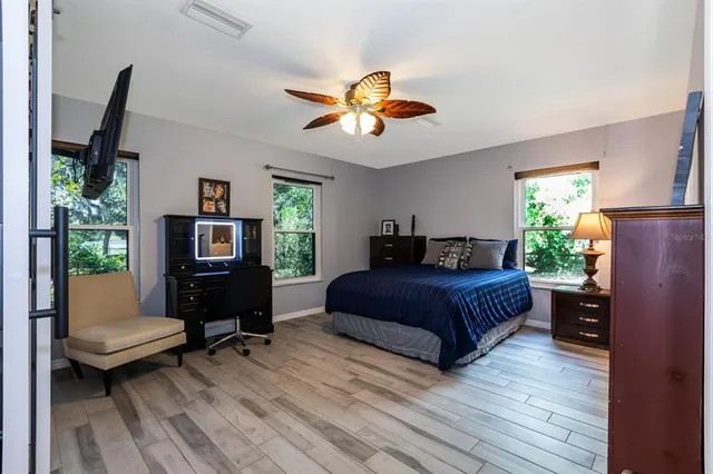 a bedroom with a bed dresser and a window