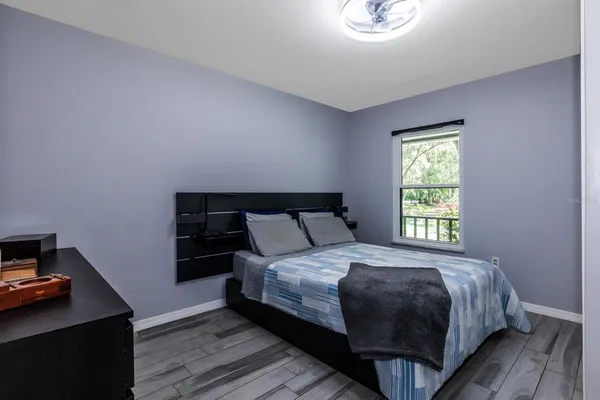 a bedroom with a bed and a window