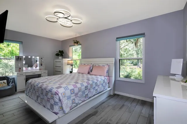 a bedroom with a bed and a chandelier