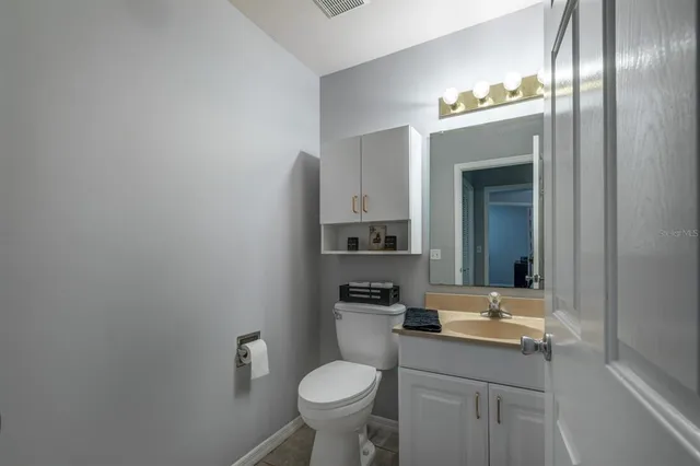 a bathroom with a sink toilet and a mirror