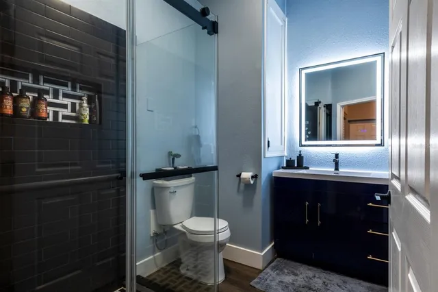 a bathroom with a toilet sink and mirror