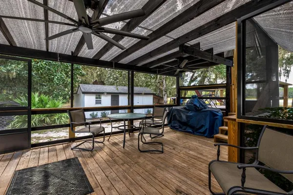a living room with furniture a wooden floor and a large window