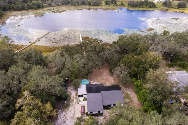 an aerial view of a house with a yard
